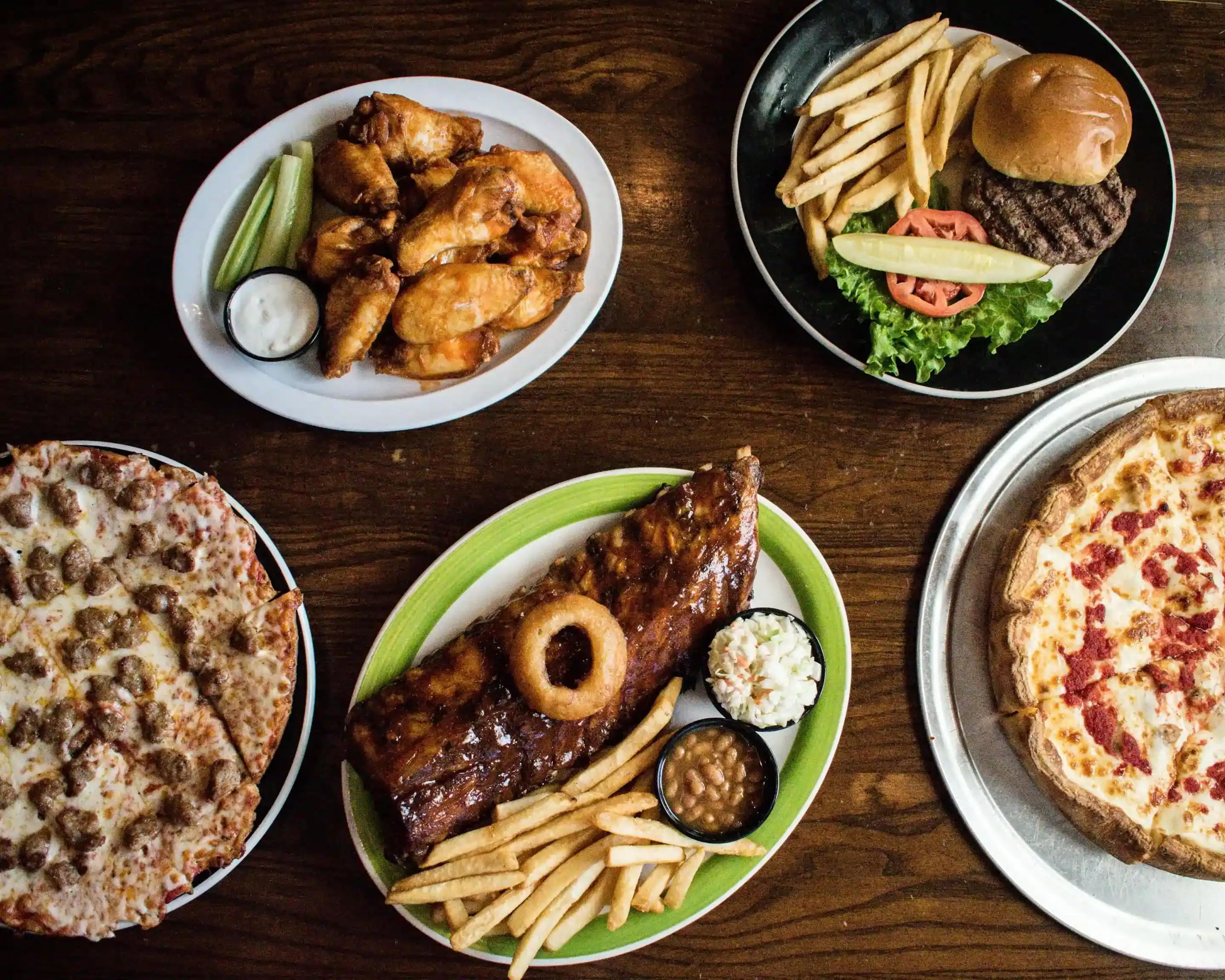 Spread of ribs, pizza, burgers and wings